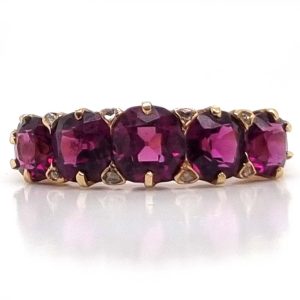 Victorian Antique Garnet Five Stone Ring with Diamonds, five graduating pinkish-red rhodolite garnets accented with rose-cut diamond points in yellow gold