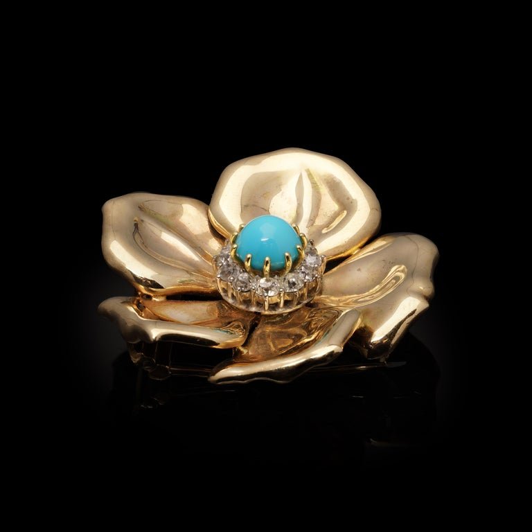 Vintage diamond and turquoise flower brooch in gold.