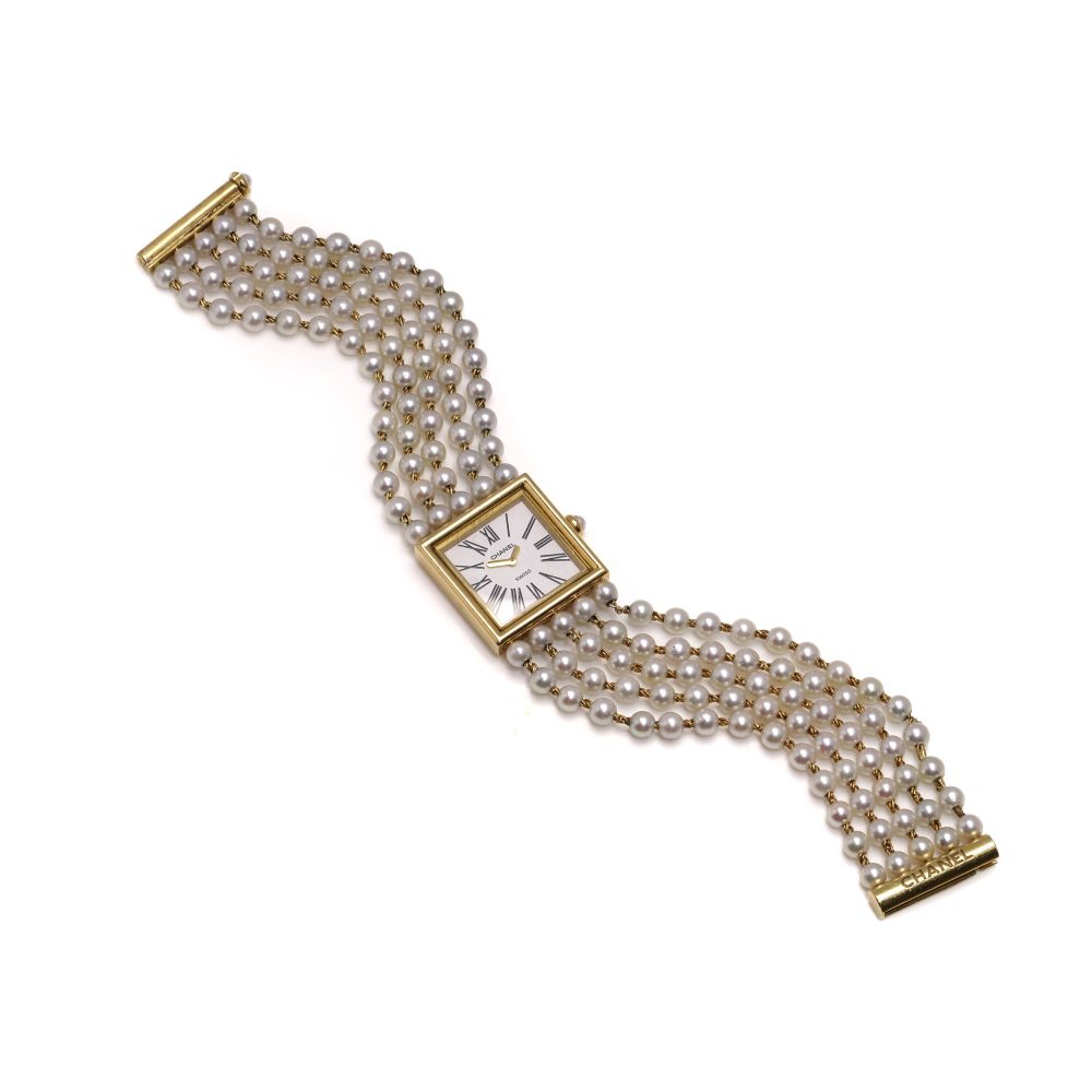 Chanel gold wristwatch with pearl bracelet.