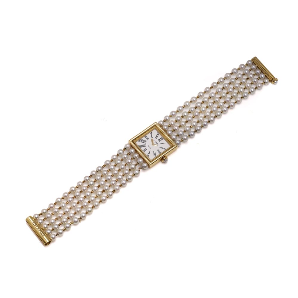 Chanel gold wristwatch with pearl bracelet.