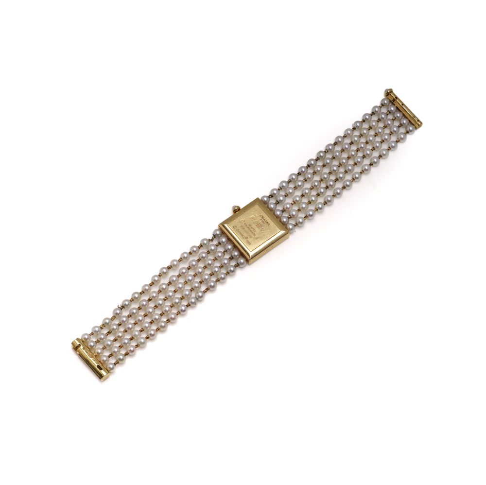 Chanel gold wristwatch with pearl bracelet.