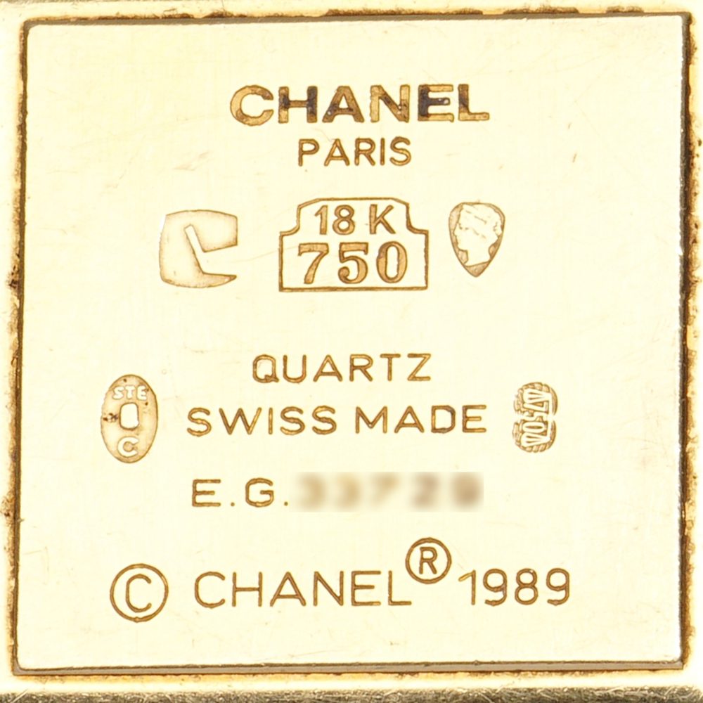 Chanel gold wristwatch with pearl bracelet.