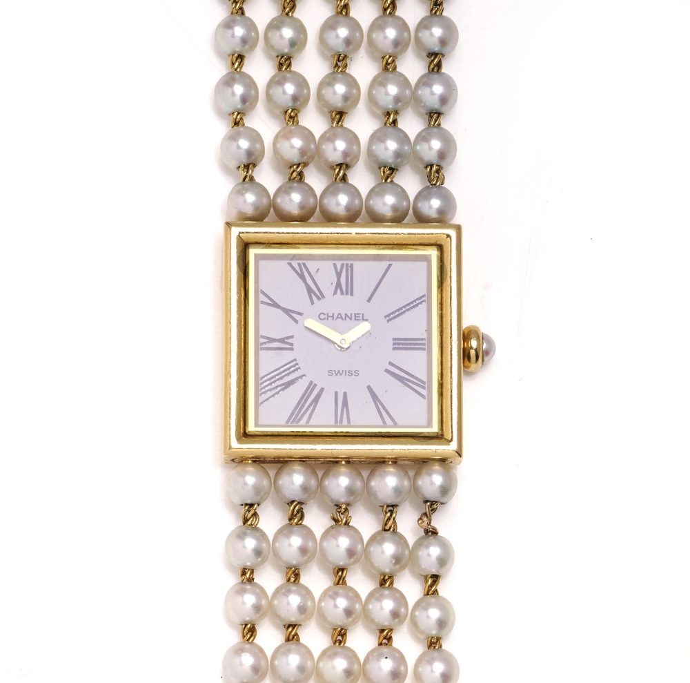 Chanel gold wristwatch with pearl bracelet.