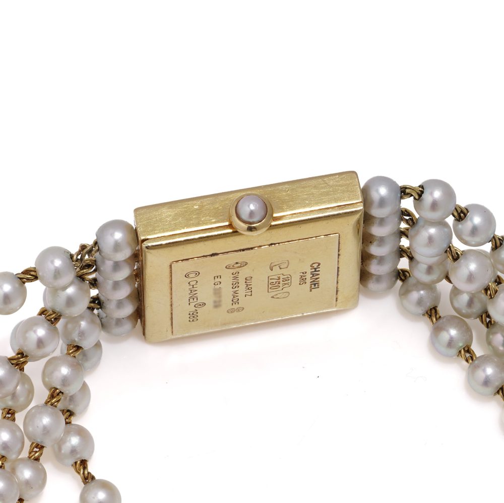 Chanel gold wristwatch with pearl bracelet.