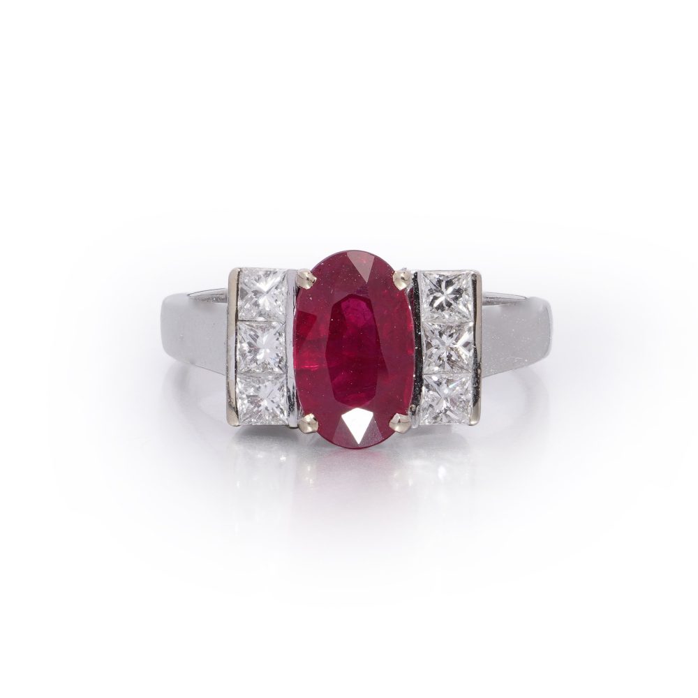 2.15ct Oval Ruby and Princess Cut Diamond Engagement Ring, vibrant oval mixed-cut natural ruby flanked by a row of vertically set square princess-cut diamonds to each side in 18ct white gold