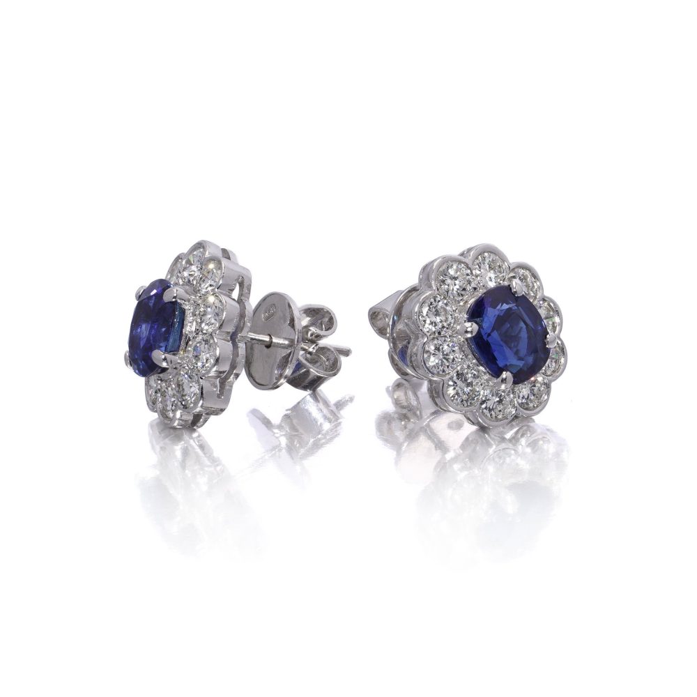 Sapphire and diamond cluster earrings in white gold.