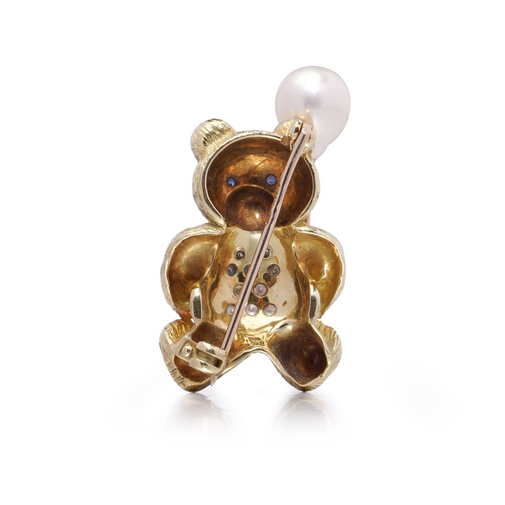Gold bear brooch with pearl balloon, diamonds and sapphires.