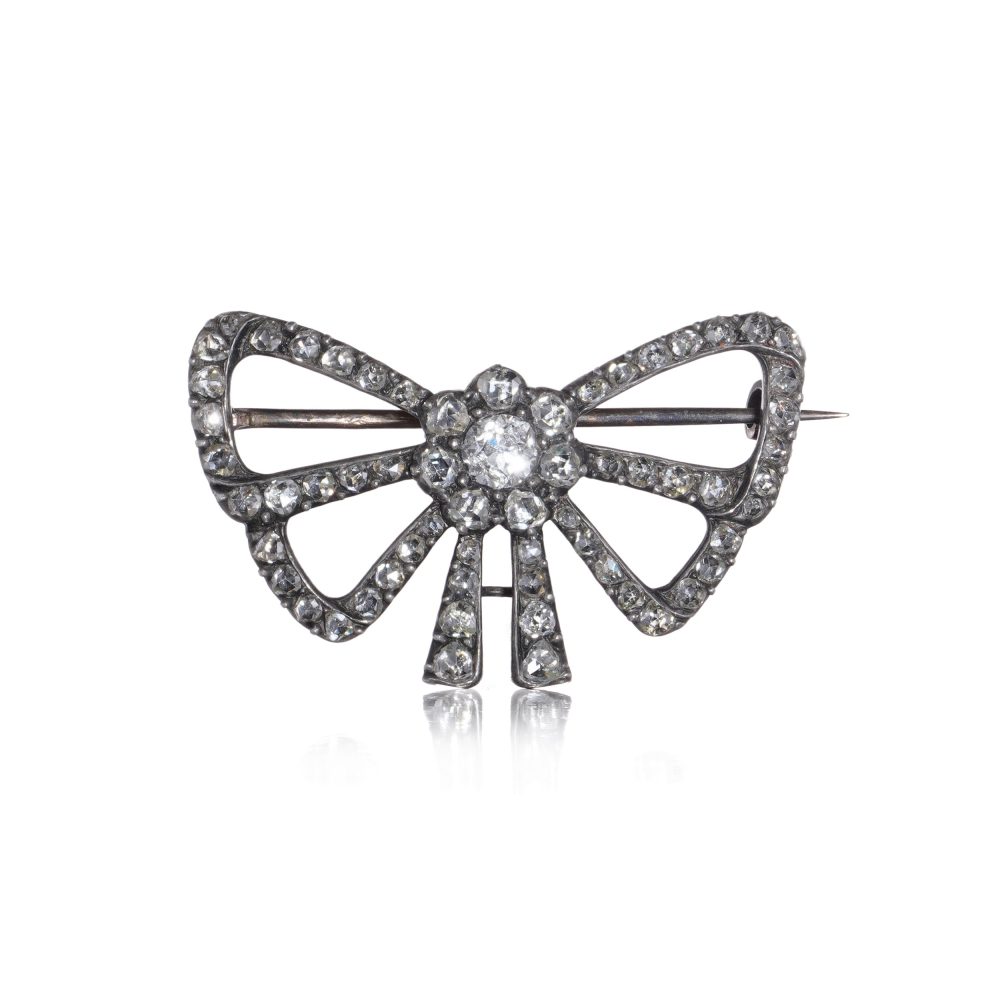 Victorian diamond bow brooch in gold and silver.