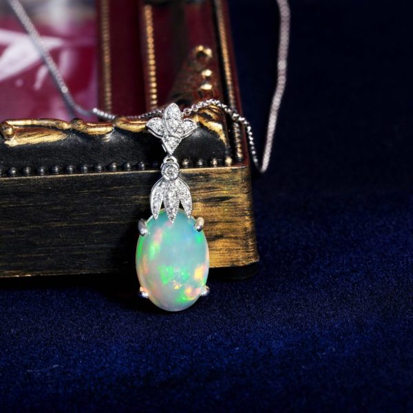 3.62ct Oval Opal and Diamond Pendant Necklace, 3.62 carat oval cabochon Australian opal with play-of-colour suspended from diamond fleur-de-lis top in 18ct white gold