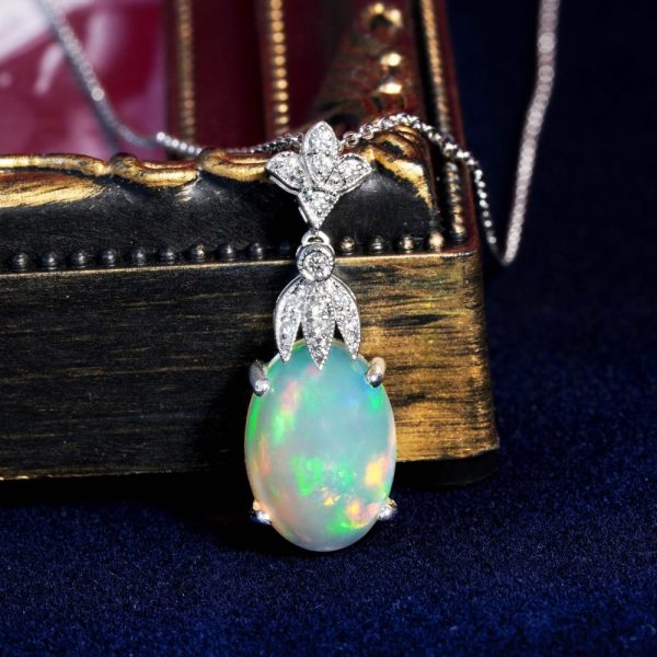 3.62ct Oval Opal and Diamond Pendant Necklace, 3.62 carat oval cabochon Australian opal with play-of-colour suspended from diamond fleur-de-lis top in 18ct white gold