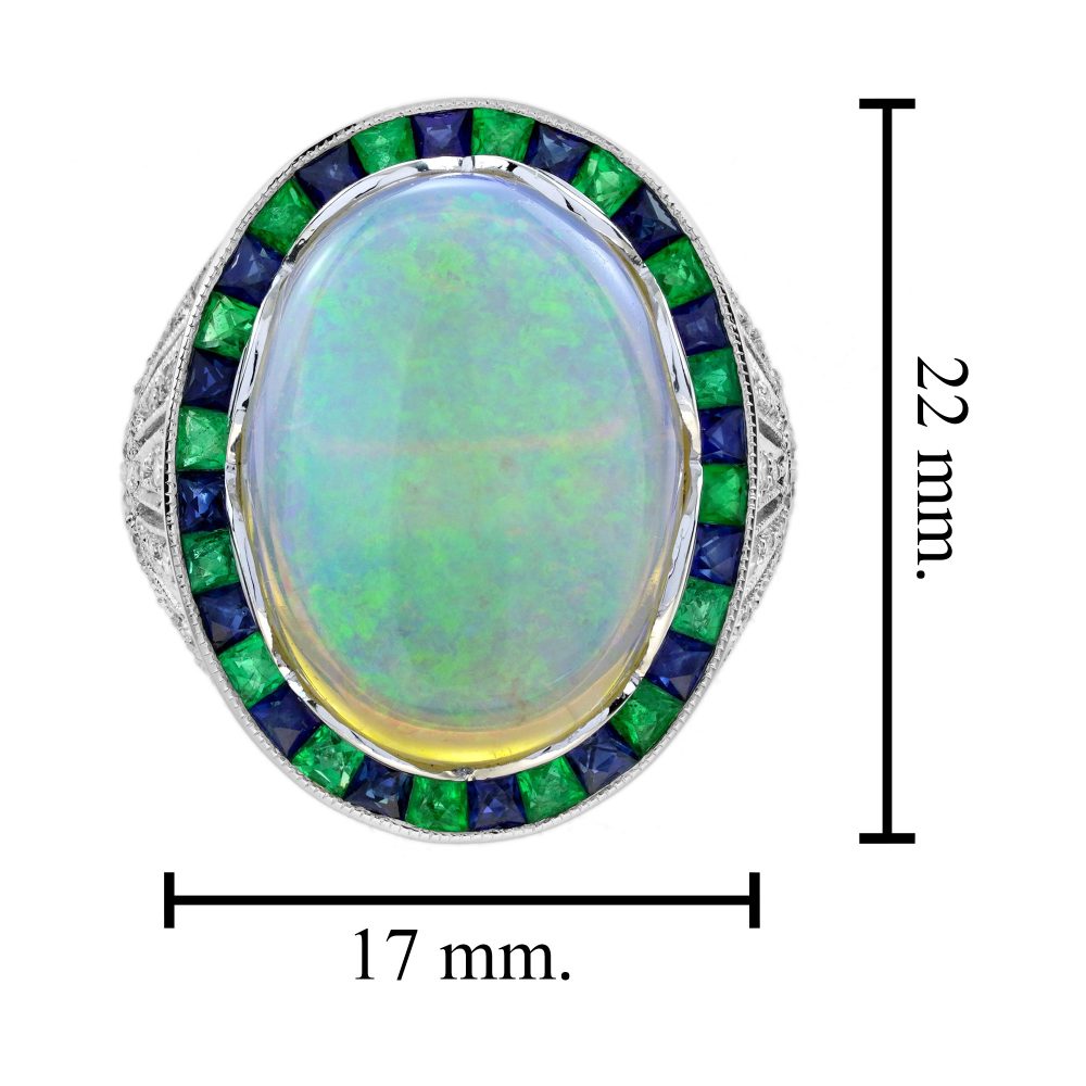 8.73ct Opal Emerald Sapphire Cluster Cocktail Ring, central luminous opal encircled by vivid French-cut emeralds alternated with blue sapphires in 18ct white gold with diamond shoulders