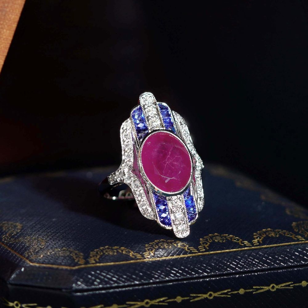 Certified 4.97ct Burma Ruby Sapphire and Diamond Cluster Plaque Ring, 4.97ct oval red Burmese ruby centrally set within alternating French-cut sapphires and brilliant diamonds striped line design in 18ct white gold with GFCO laboratory report