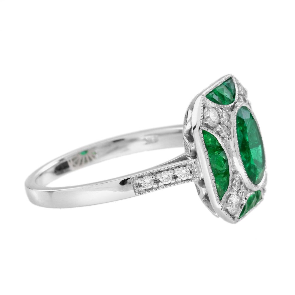 Art Deco Inspired 1.25ct Emerald and Diamond Cluster Engagement Ring, 1.25 carat oval emerald surrounded by sparkling brilliant diamonds accented with four half-moon shaped emerald sections set at each side of the square halo in 18ct white gold