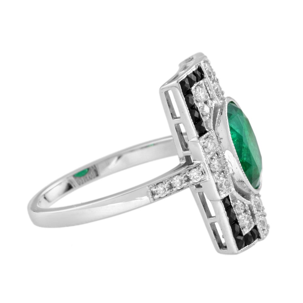 1.80ct. Emerald Diamond and Black Onyx Cluster Plaque Ring, 1.80ct oval vivid green emerald surrounded by sparkling diamonds framed with a sleek black onyx border in 18ct white gold