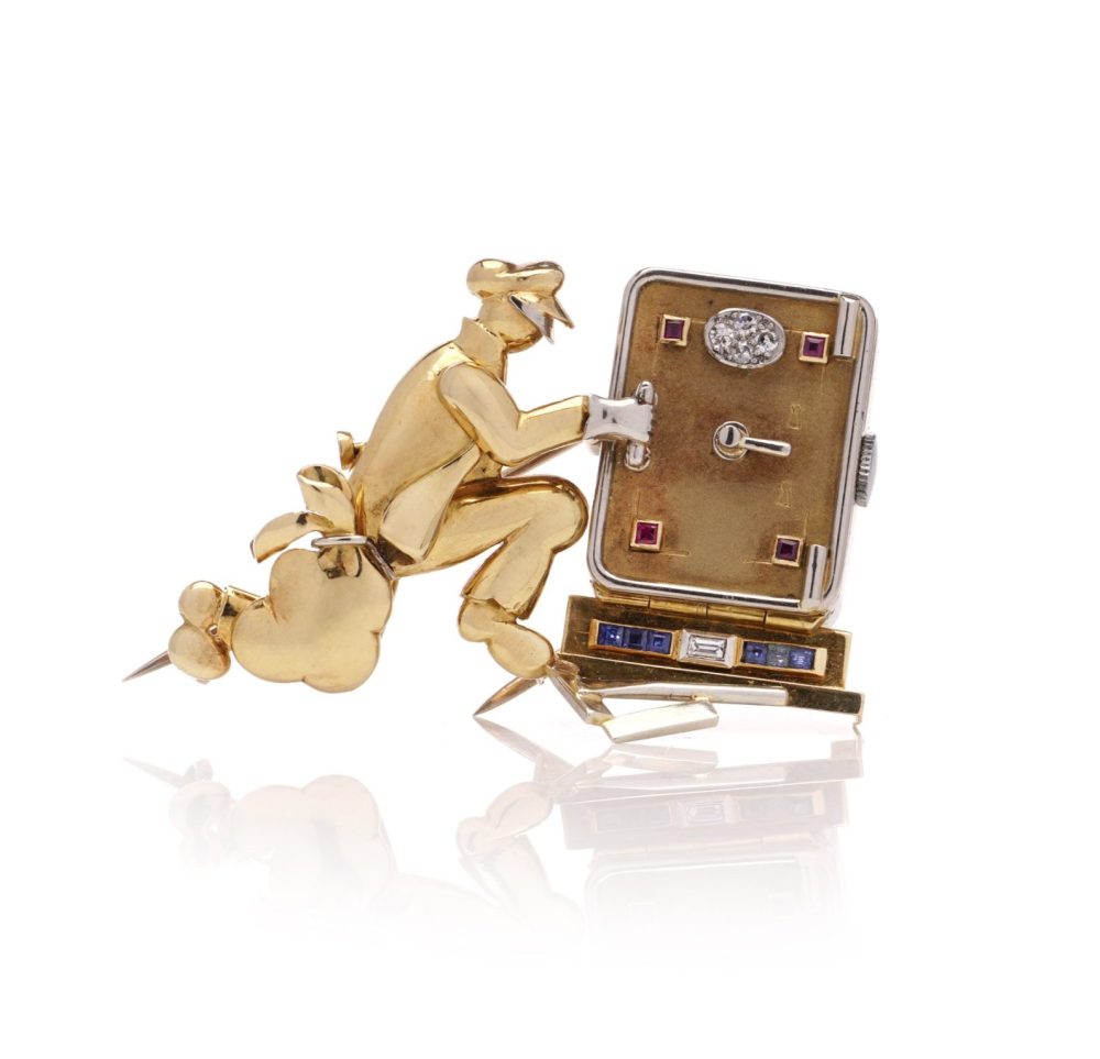 Vintage gold brooch/watch set with gemstones.