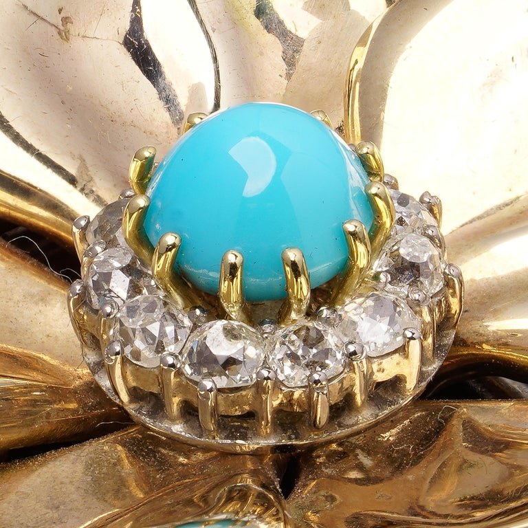 Vintage diamond and turquoise flower brooch in gold.