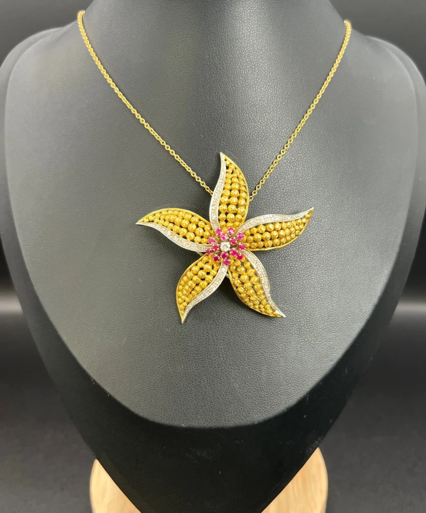 Vintage Diamond Ruby Gold and Platinum Flower Brooch come Pendant, diamond and ruby cluster leads to 18ct yellow gold textured striking petals accented with platinum edges. Circa 1970s