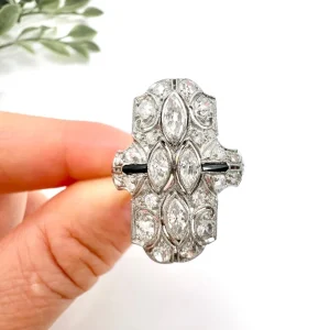 Vintage Marquise Diamond and Onyx Plaque Ring, shield-shape set with marquise and brilliant-cut diamonds with striking onyx accents in platinum. Circa 2000