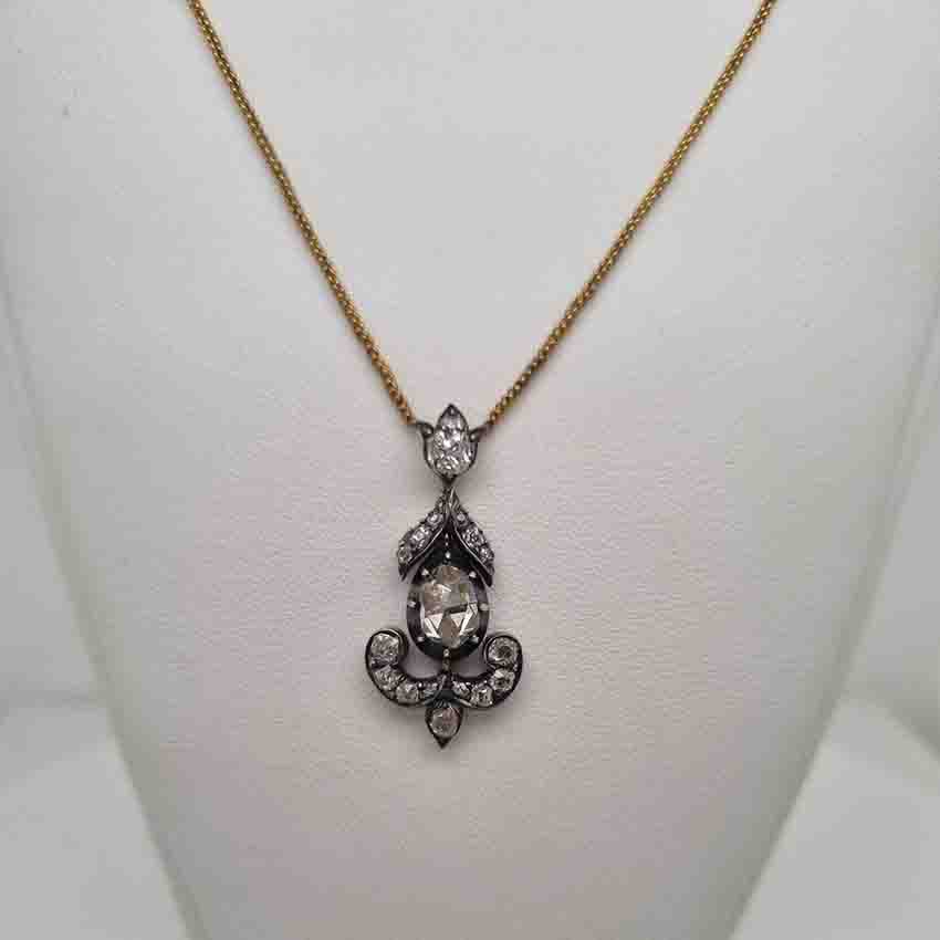 Antique 1ct Rose Cut Diamond Pendant, 1.60 carat total, closed-back 1ct rose-cut diamond surrounded by 0.60 carats of old mine-cut diamonds in floral, leaf and scroll design in silver upon gold