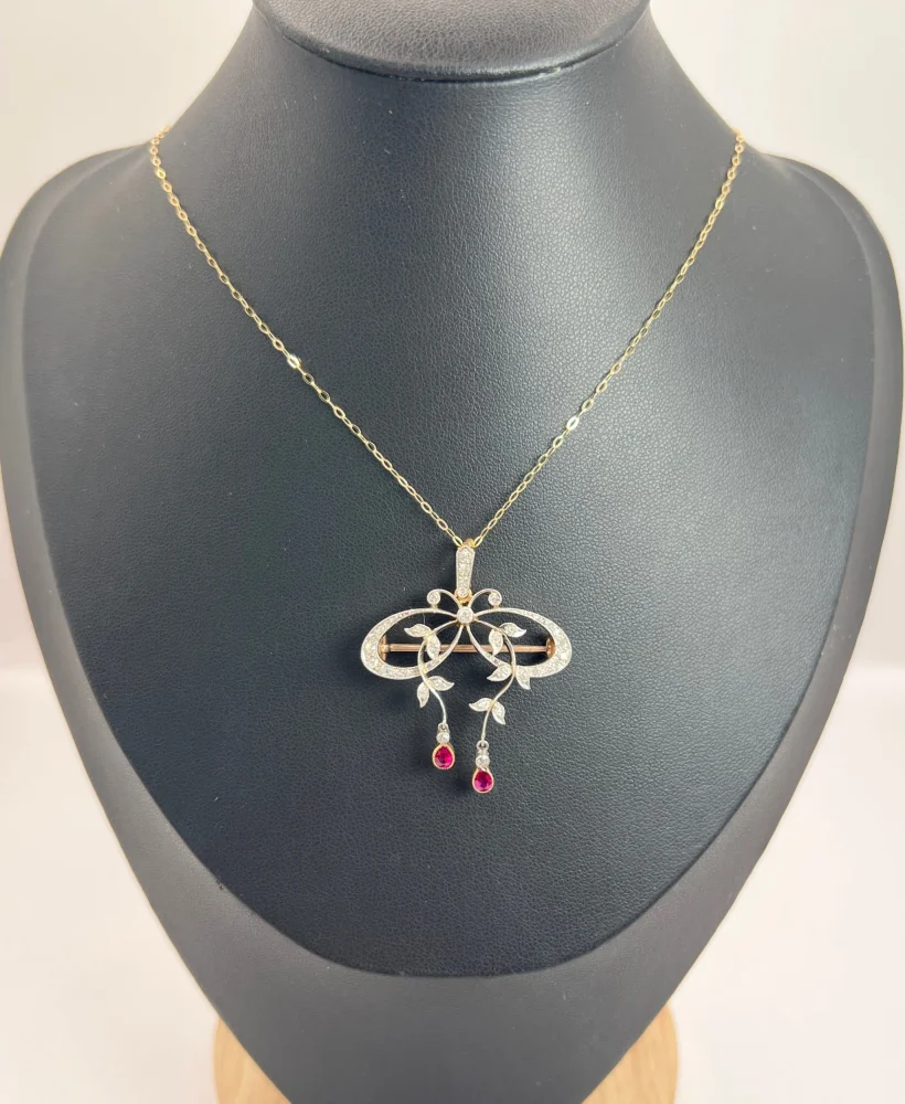 Belle Epoque Edwardian Antique Diamond Bow Pendant Brooch with Ruby Drops with enchanting vine motifs in platinum and yellow gold, Circa 1910