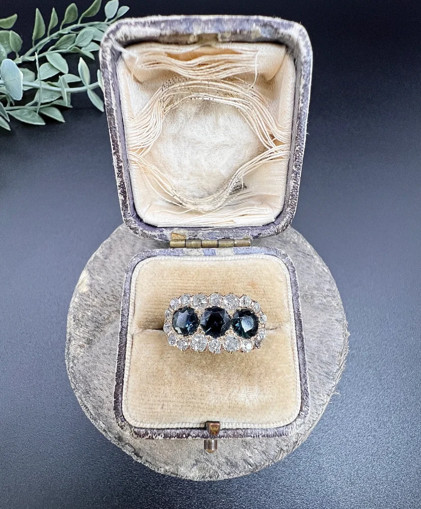 Edwardian Antique Sapphire and Diamond Triple Cluster Ring, trilogy sapphires framed by halos of sparkling old-cut diamonds in 18ct rose gold. Circa 1900