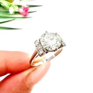 Antique Art Deco 1.20ct Diamond Solitaire Engagement Ring in 18ct White Gold, single stone diamond beautifully complemented by three smaller diamonds rectangular arrangements on either side. Circa 1920s