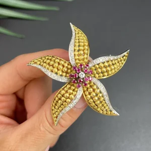 Vintage Diamond Ruby Gold and Platinum Flower Brooch come Pendant, diamond and ruby cluster leads to 18ct yellow gold textured striking petals accented with platinum edges. Circa 1970s