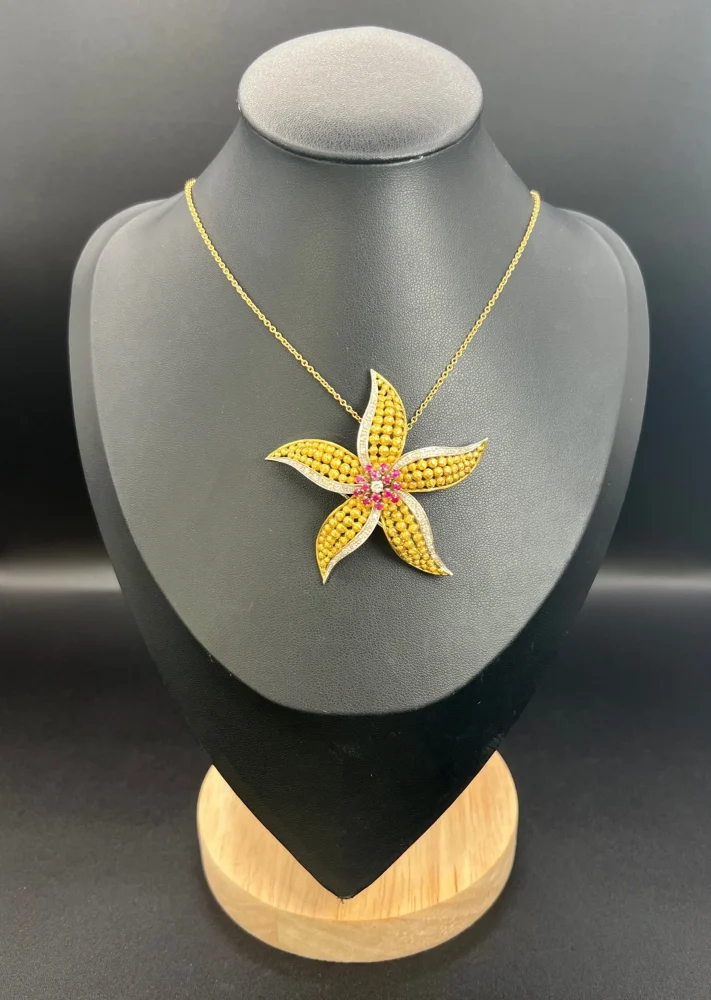 Vintage Diamond Ruby Gold and Platinum Flower Brooch come Pendant, diamond and ruby cluster leads to 18ct yellow gold textured striking petals accented with platinum edges. Circa 1970s