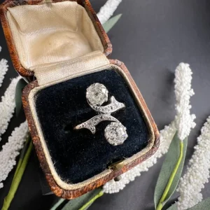 Belle Epoque Antique Diamond Toi et Moi Two Stone Ring, Claw set with cushion-cut diamonds with 'vine' design diamond shoulders in 18ct gold. Circa 1900