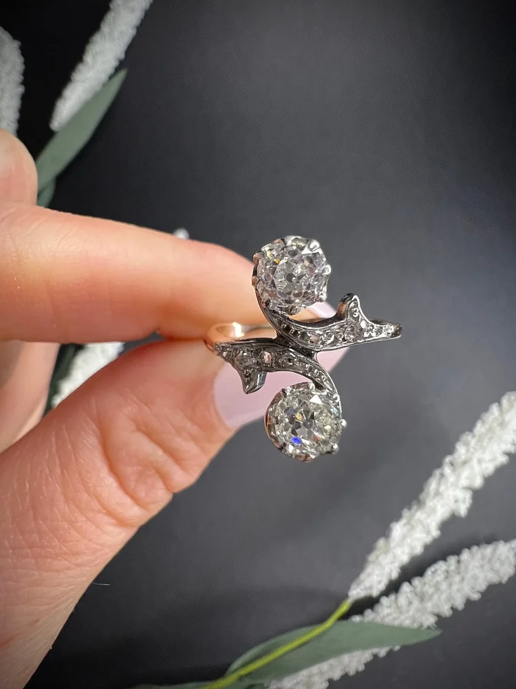 Belle Epoque Antique Diamond Toi et Moi Two Stone Ring, Claw set with cushion-cut diamonds with 'vine' design diamond shoulders in 18ct gold. Circa 1900