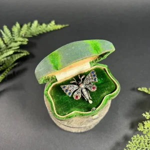 Antique, butterfly brooch in rose gold and silver with gemstones.