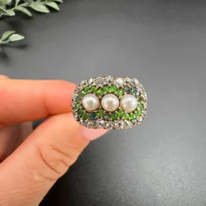 Antique trilogy cluster ring with gemstones in gold.