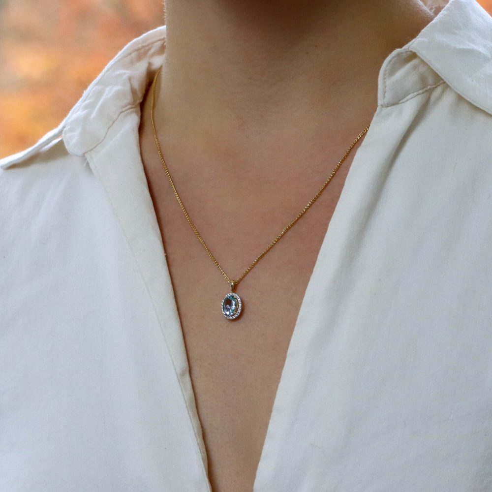 Oval Aquamarine and Diamond Halo Cluster Pendant in 18ct Yellow Gold, 1.12ct oval-cut sky blue aquamarine surrounded by 24 sparkling brilliant diamonds on polished gold bail