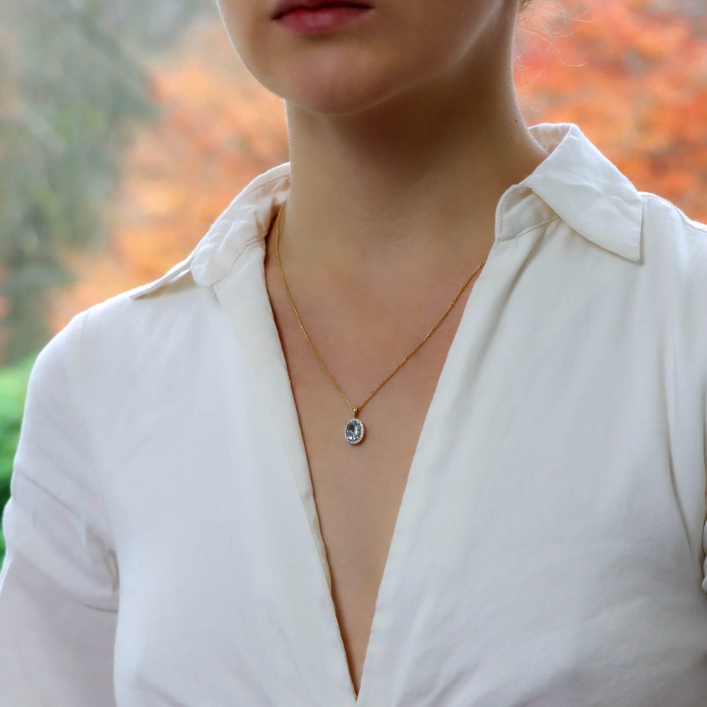 Oval Aquamarine and Diamond Halo Cluster Pendant in 18ct Yellow Gold, 1.12ct oval-cut sky blue aquamarine surrounded by 24 sparkling brilliant diamonds on polished gold bail