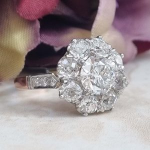 Victorian Antique Old Cut Diamond Cluster Engagement Ring, 2.79 carat total, 1.19ct old European transitional cut diamond surrounded by 1.60 carats of old-cut diamonds set in platinum to blush gold gallery and shank, Circa 1895