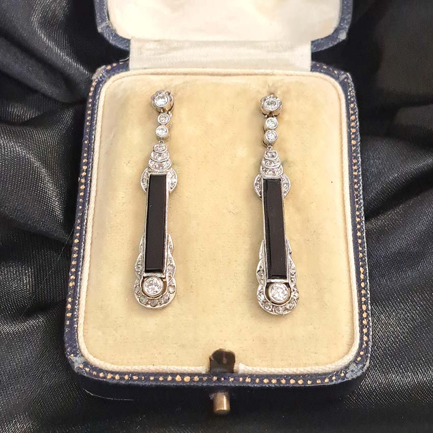 Art Deco Onyx and Diamond Drop Earrings, Elongated strong black onyx framed by rose-cut diamonds accented with further sparkling diamonds in 14ct white gold. Circa 1920s