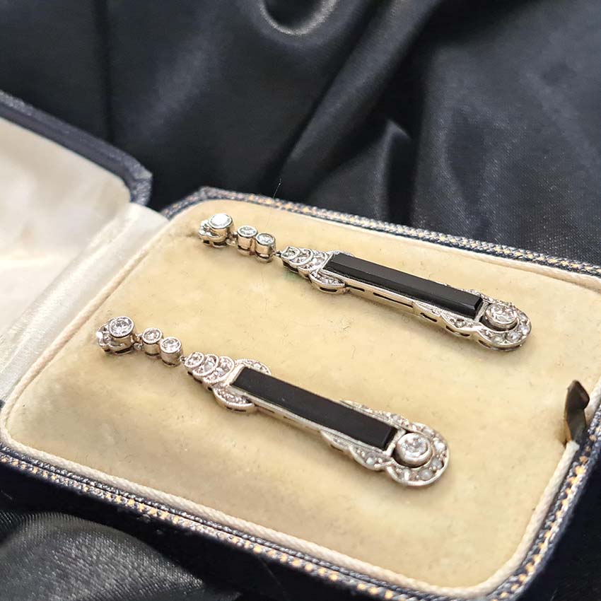Art Deco Onyx and Diamond Drop Earrings, Elongated strong black onyx framed by rose-cut diamonds accented with further sparkling diamonds in 14ct white gold. Circa 1920s