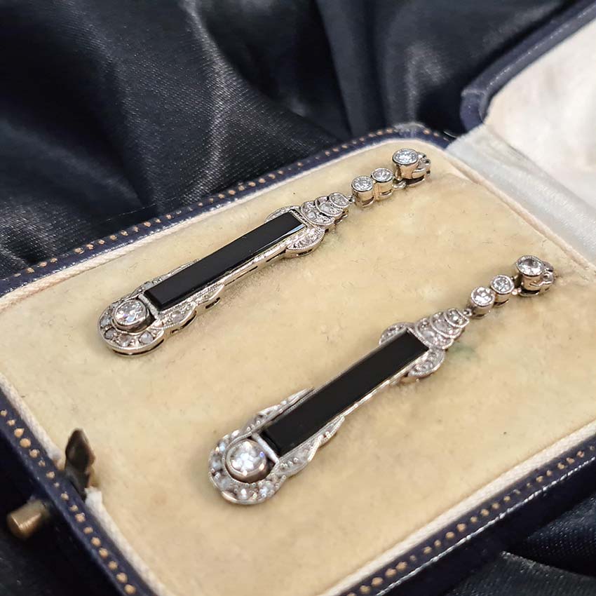 Art Deco Onyx and Diamond Drop Earrings, Elongated strong black onyx framed by rose-cut diamonds accented with further sparkling diamonds in 14ct white gold. Circa 1920s