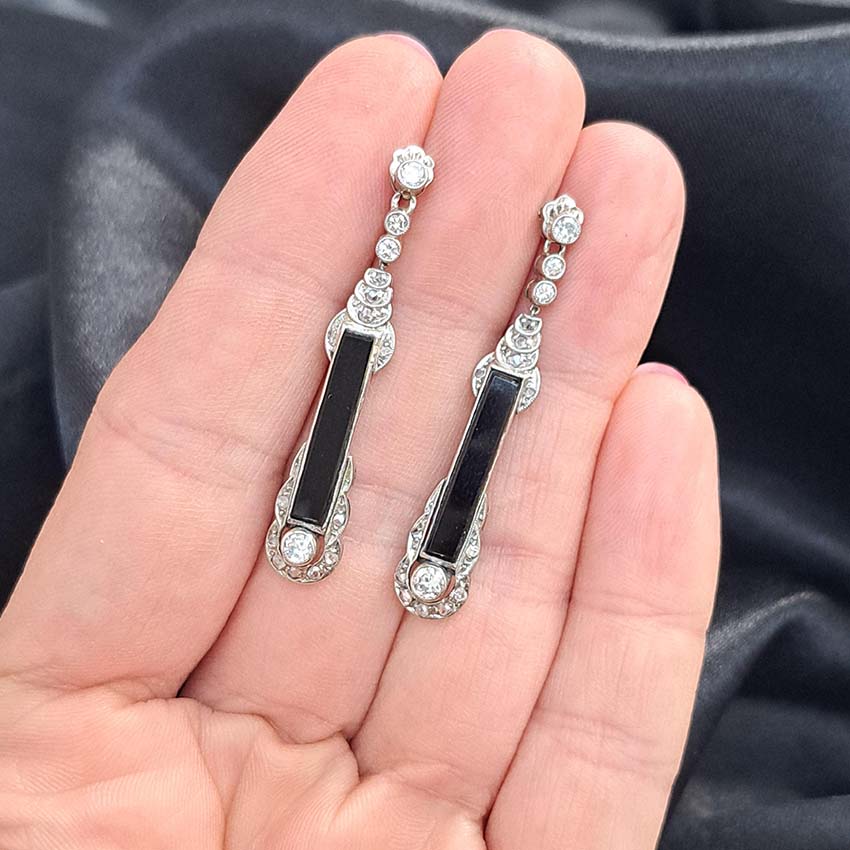 Art Deco Onyx and Diamond Drop Earrings, Elongated strong black onyx framed by rose-cut diamonds accented with further sparkling diamonds in 14ct white gold. Circa 1920s