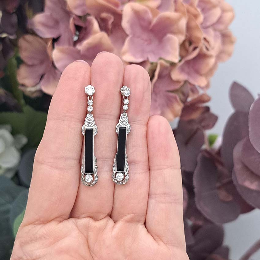 Art Deco Onyx and Diamond Drop Earrings, Elongated strong black onyx framed by rose-cut diamonds accented with further sparkling diamonds in 14ct white gold. Circa 1920s