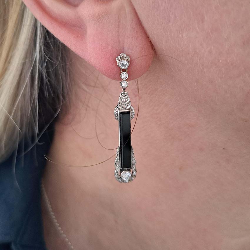 Art Deco Onyx and Diamond Drop Earrings, Elongated strong black onyx framed by rose-cut diamonds accented with further sparkling diamonds in 14ct white gold. Circa 1920s