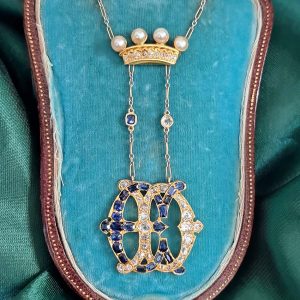 Edwardian Antique Marchioness Sapphire and Diamond Wedding Pendant, gold crown topped with four pearls suspends entwined E and D set with old mine cut diamonds and sapphires on fixed gold trombone and platinum fine link chain