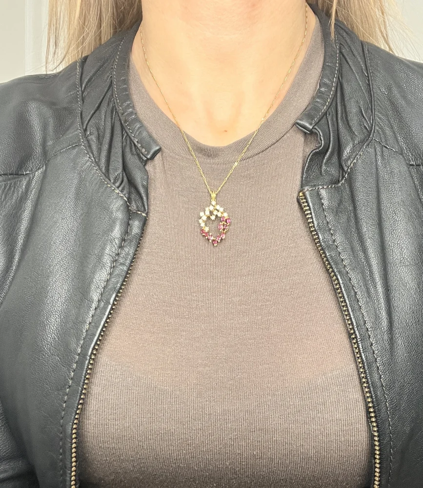 Vintage ruby and diamond heart pendant and chain in gold.