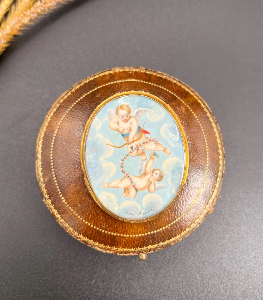 Antique cupid brooch in gold with mother-of-pearl back.