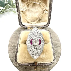 Vintage Diamond and Ruby Cluster Marquise Navette Shaped Ring, 3.5mm diamond sits prominent within diamond surround with rich red ruby accents in platinum. Circa 2000