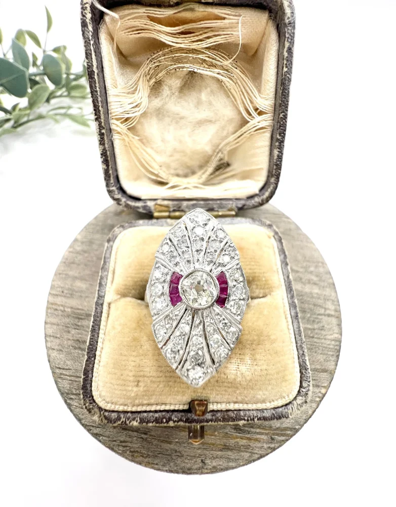 Vintage Diamond and Ruby Cluster Marquise Navette Shaped Ring, 3.5mm diamond sits prominent within diamond surround with rich red ruby accents in platinum. Circa 2000