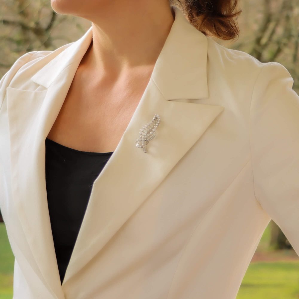 Diamond feather brooch in white gold.