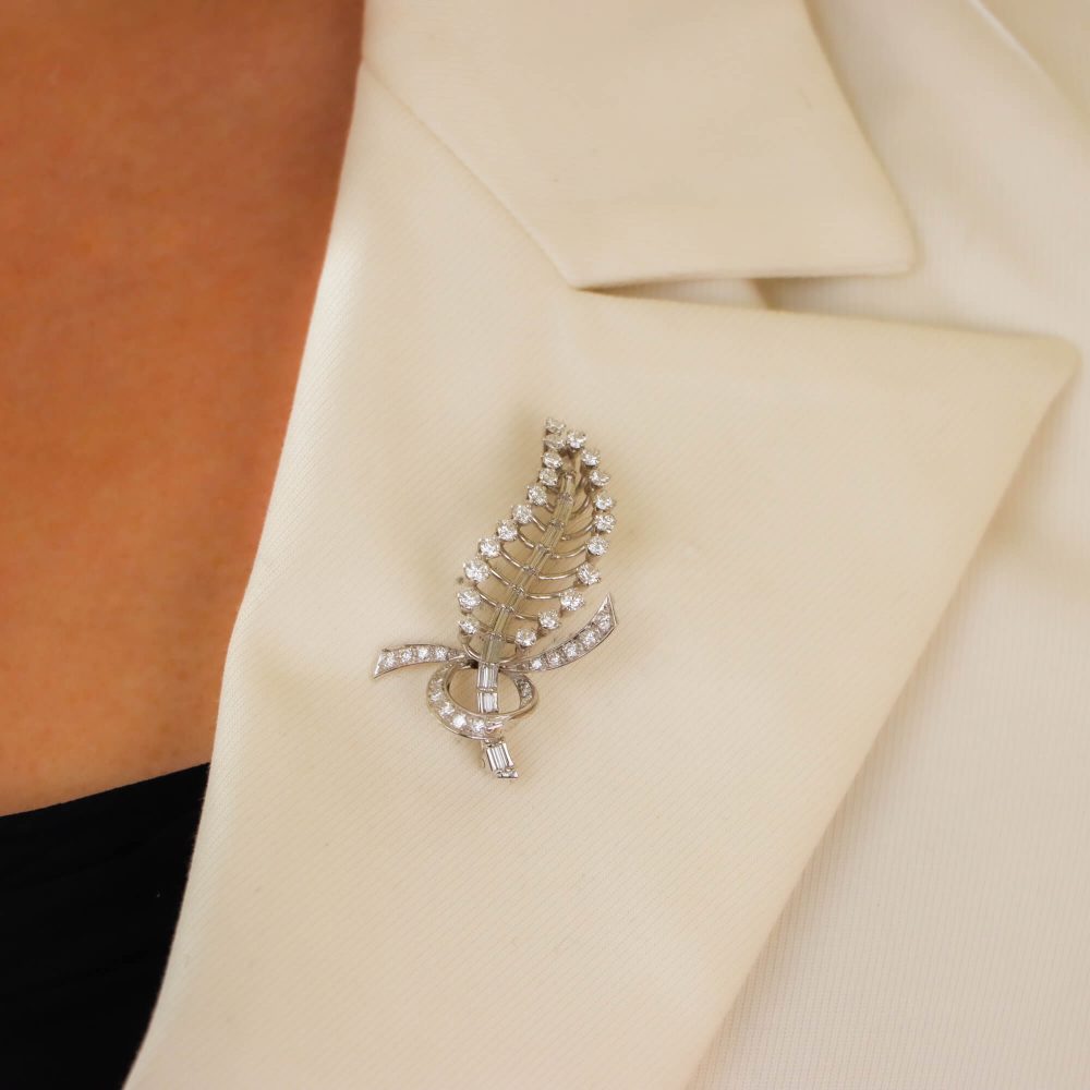 Diamond feather brooch in white gold.