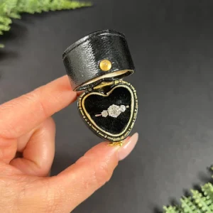 Vintage three stone diamond engagement ring in white gold.