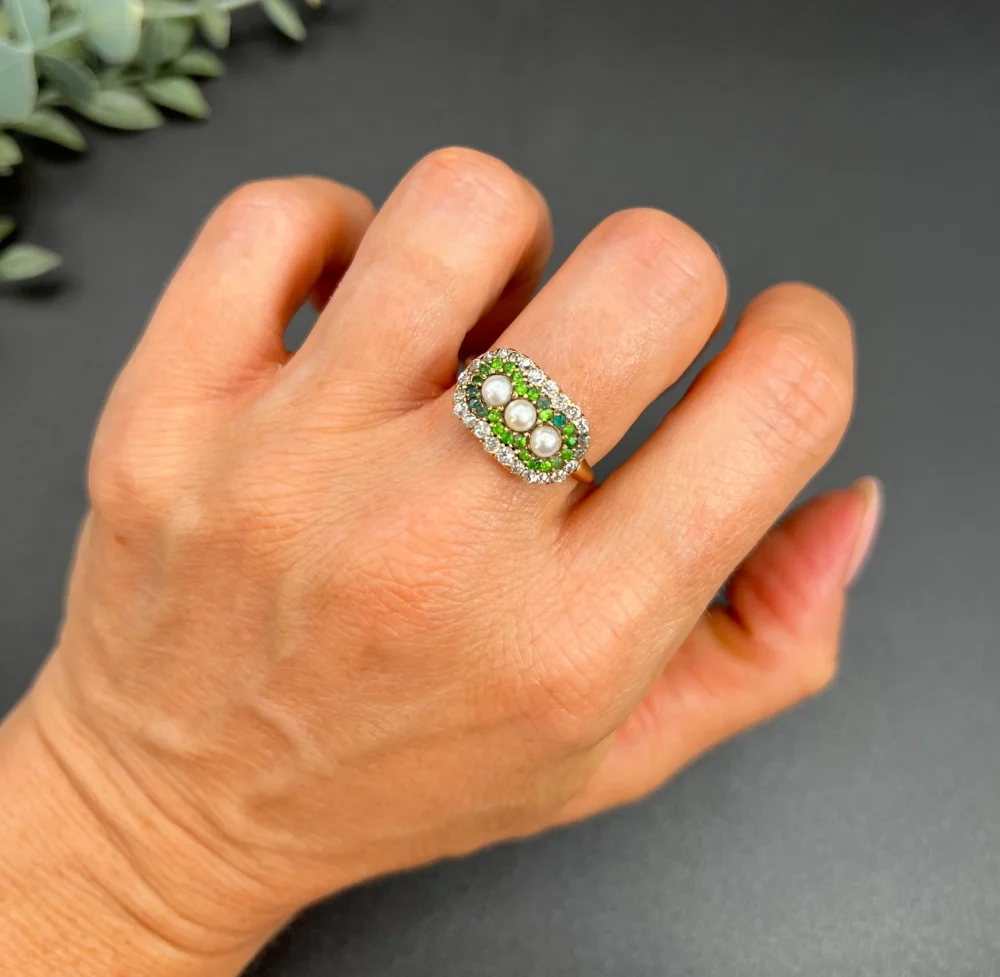 Antique trilogy cluster ring with gemstones in gold.